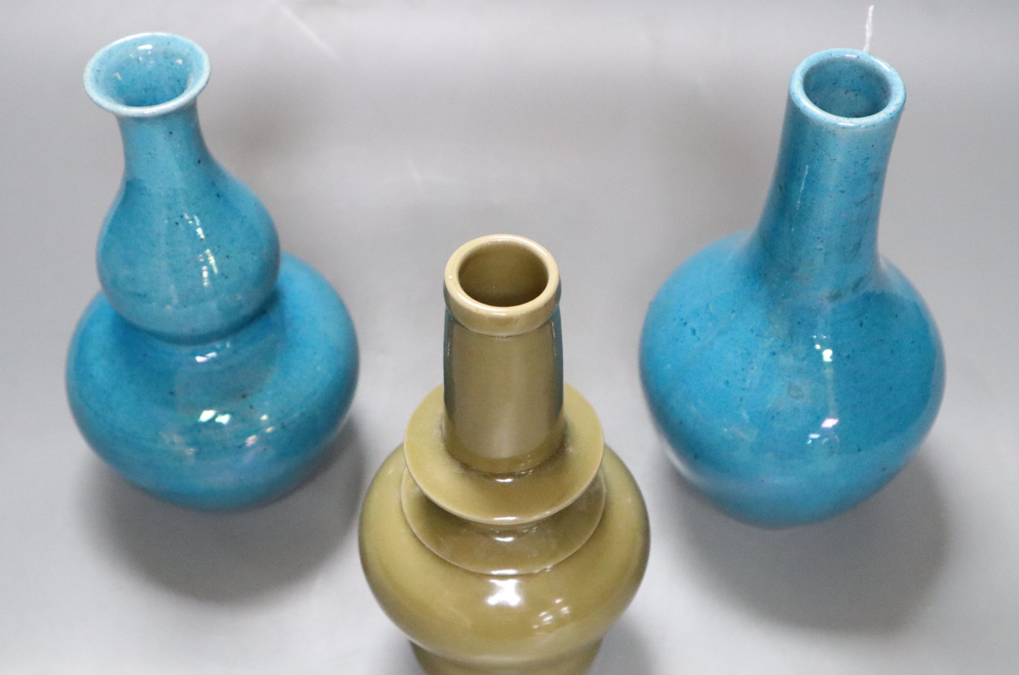 Two Chinese turquoise glazed vases and a celadon glazed bottle vase, height 20cm